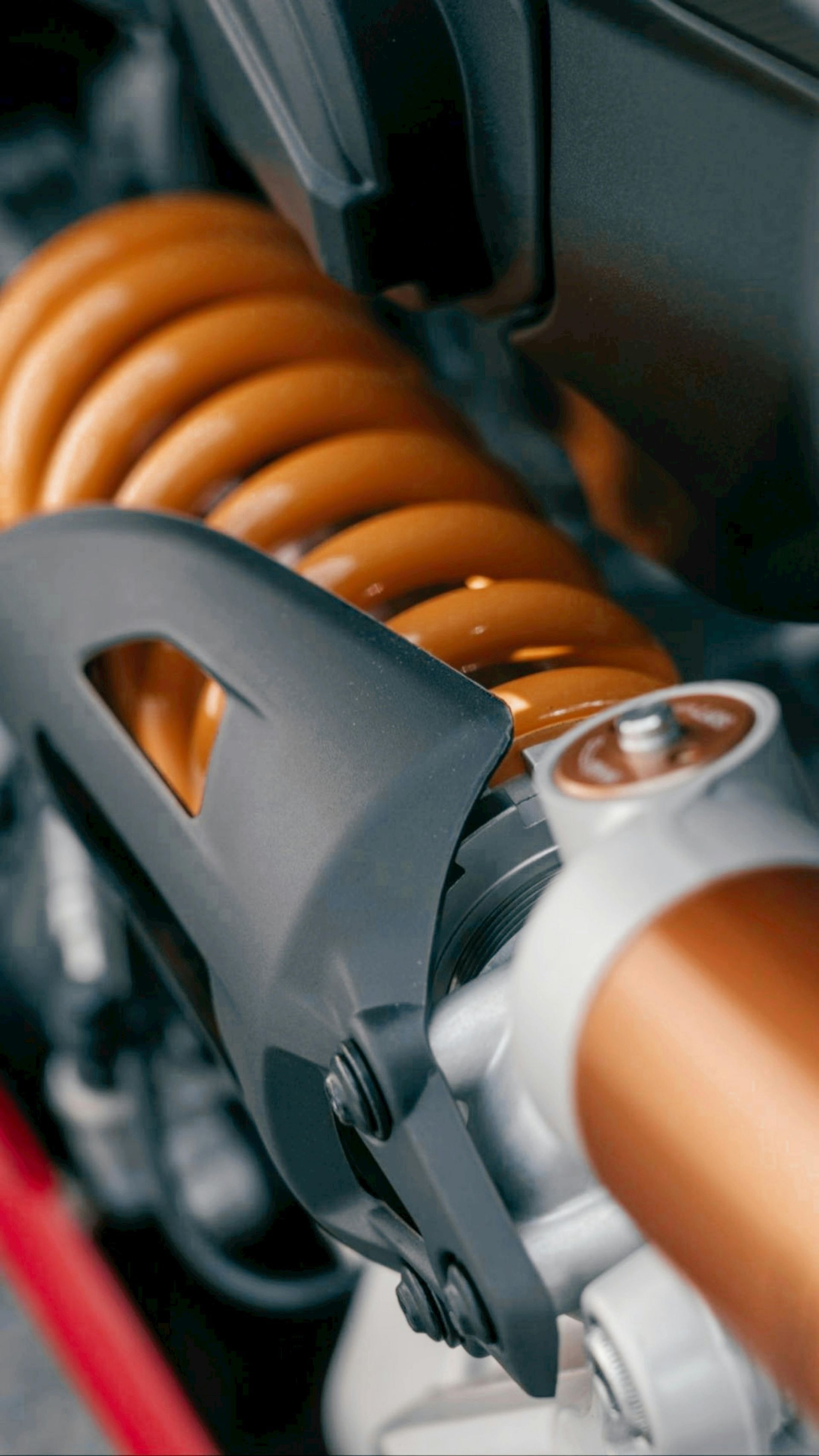A close up of a shock absorber on a motorcycle.