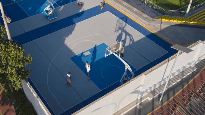 “Aerial view of a modern blue backyard basketball court with players and clean court markings during a court builder service in Tucson, AZ”