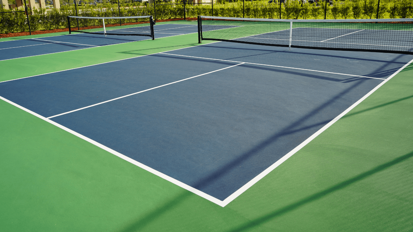 “Clean outdoor pickleball court with blue playing area, green border, and white lines after a court builder service in Tucson, AZ”