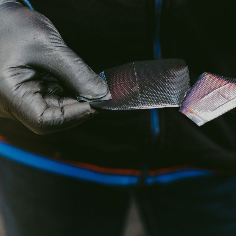 technician holding tire patch