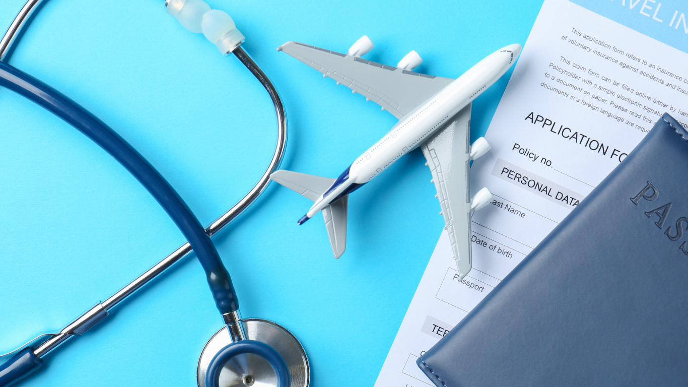 Blue stethoscope, toy airplane, passport, and travel insurance application on a light blue background, representing travel health and preparation.