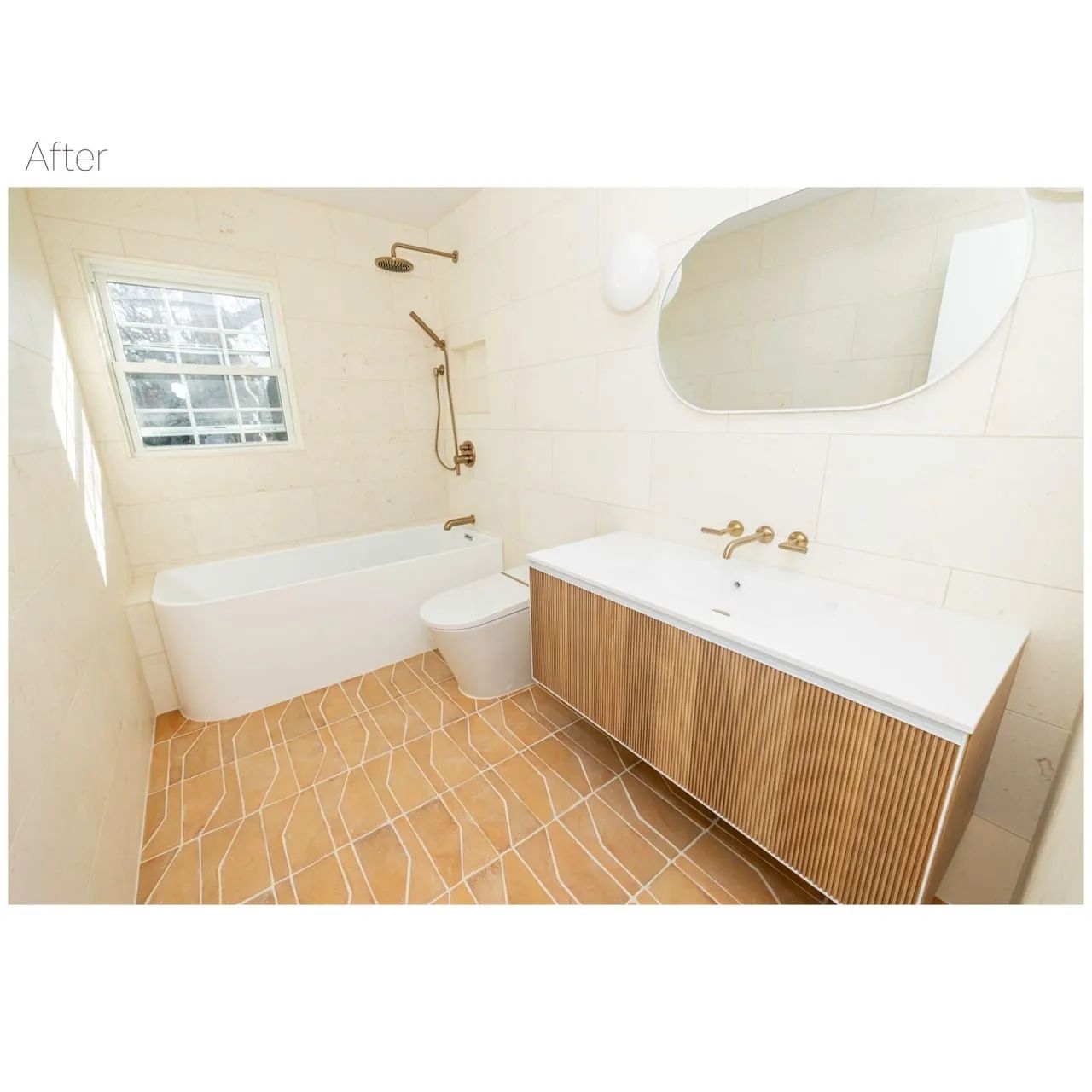 Bathroom with white bathtub, toilet, and vanity with gold fixtures; orange tile floor.