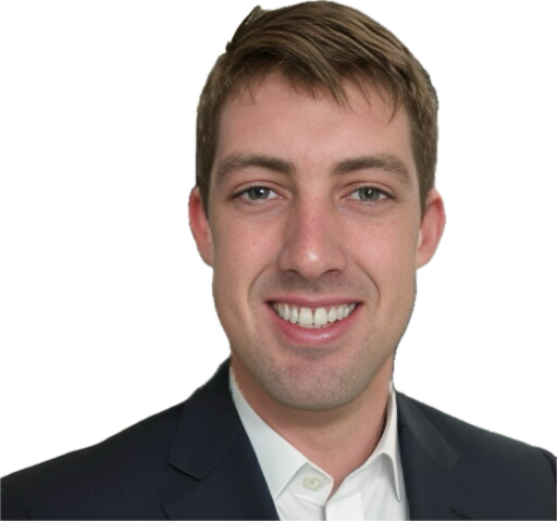 Man in a dark suit smiles at the camera against a white background.