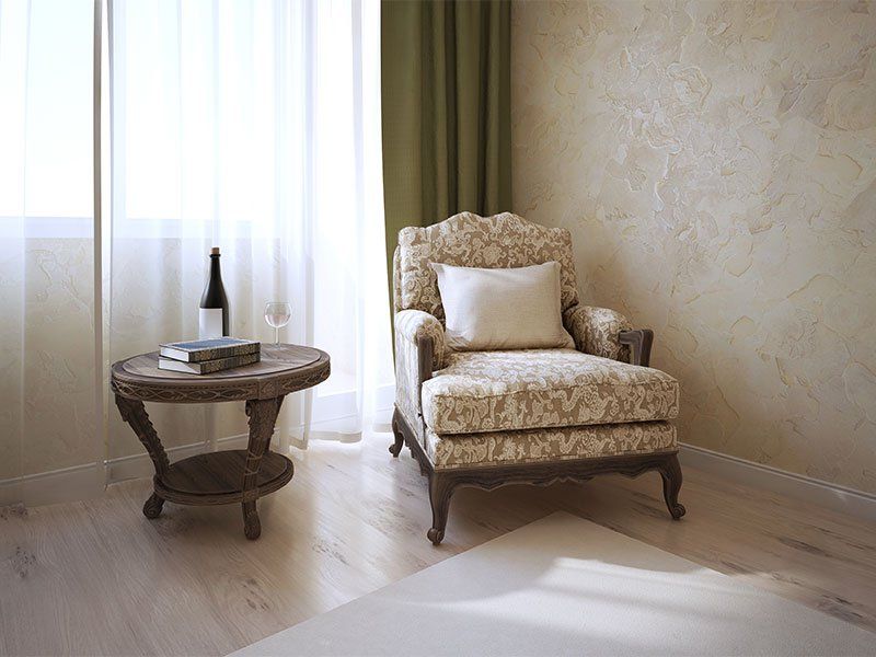 There is a chair and a table in the room.