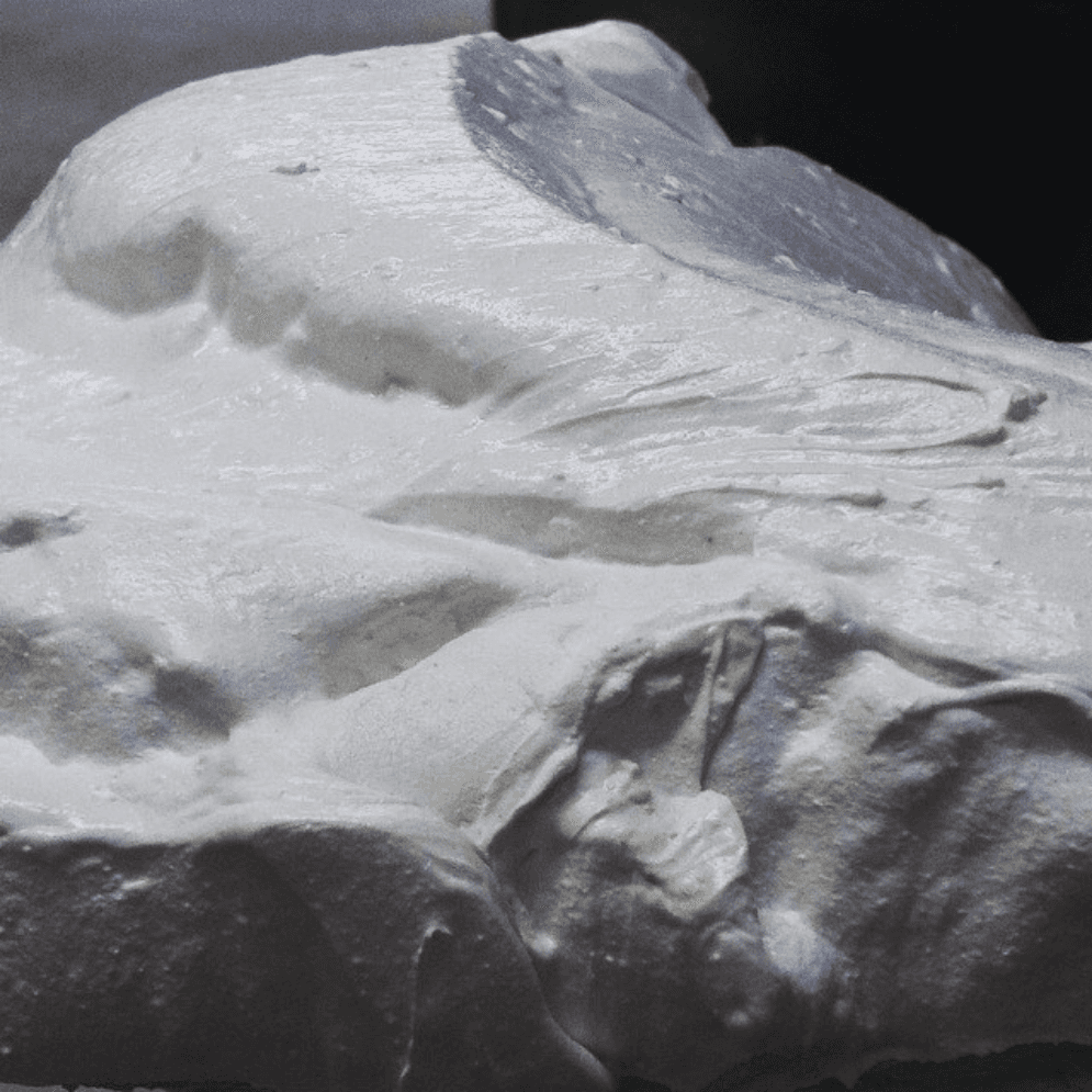 A close up of a piece of white foam on a table.