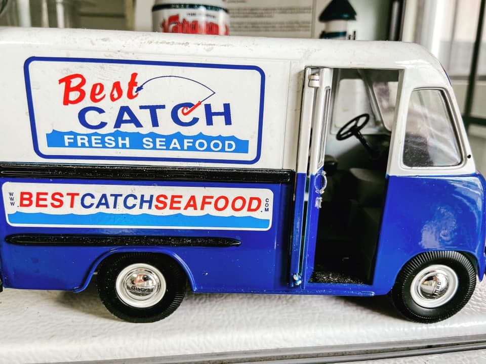 A blue and white model delivery truck with 