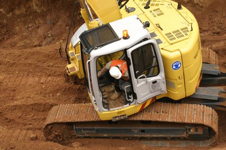 worker driving the excavator