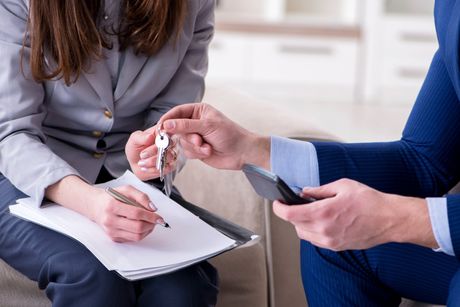 man handling the key to the woman