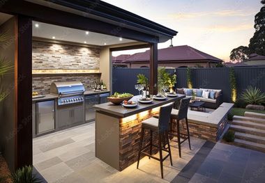 Outdoor patio with built-in grill, dining table, and lounge seating at dusk