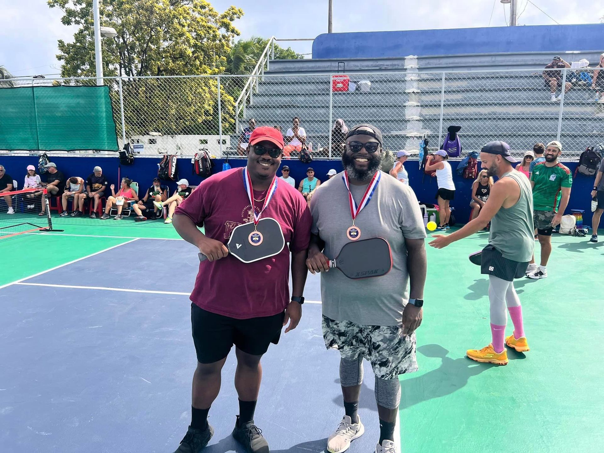 A group of people are playing pickleball on a court at the Playa Del Carmen Pickleball Club in Playa Del Carmen, Mexico