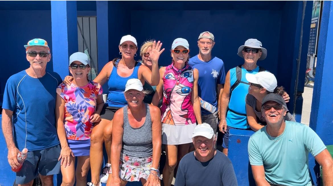 A group of people are shaking hands on a pickleball court.