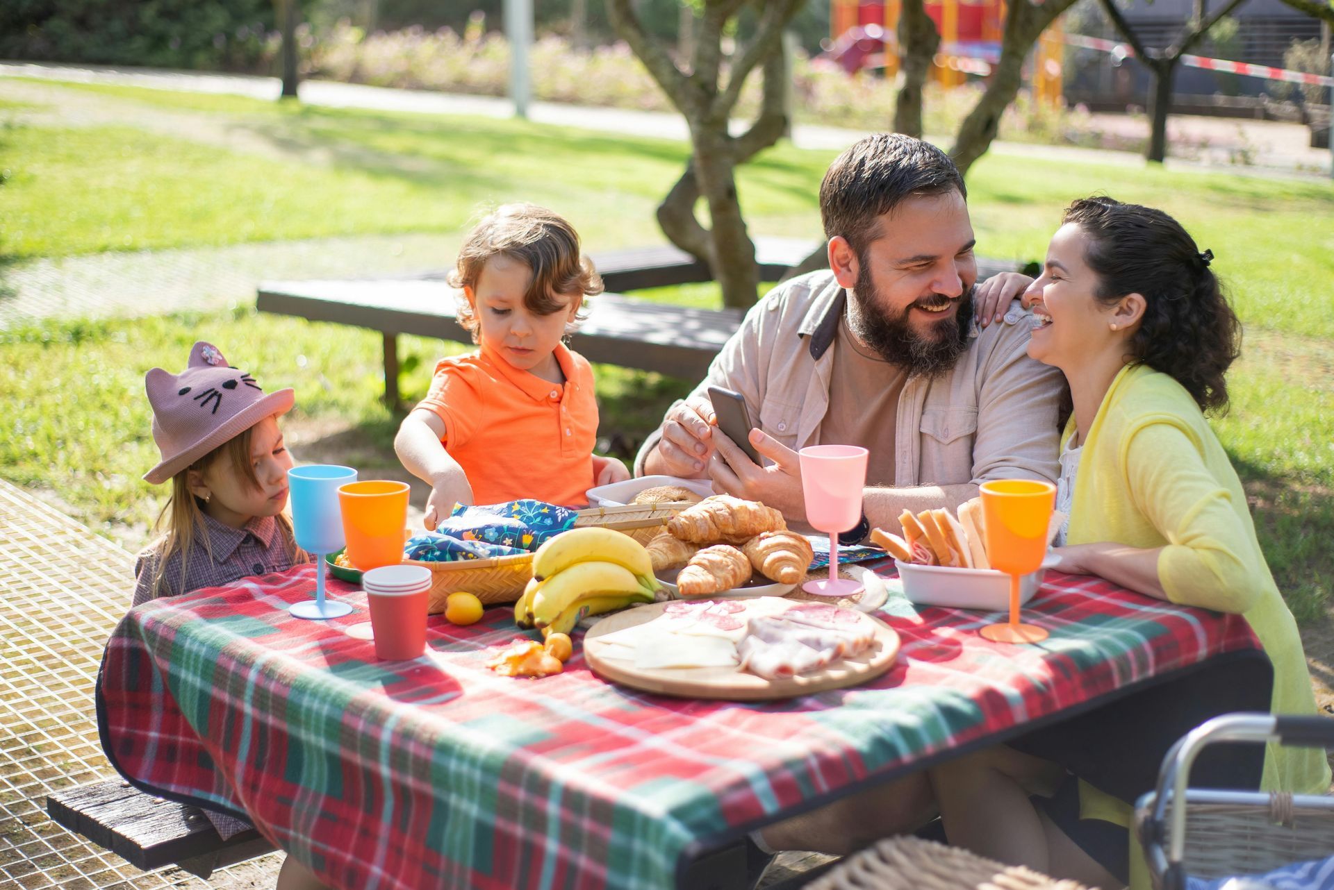 Family enjoying a picnic together at a park