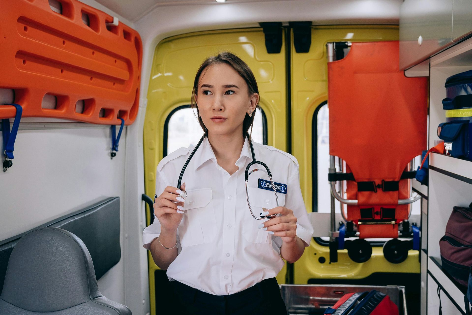 A female paramedic inside an ambulance.