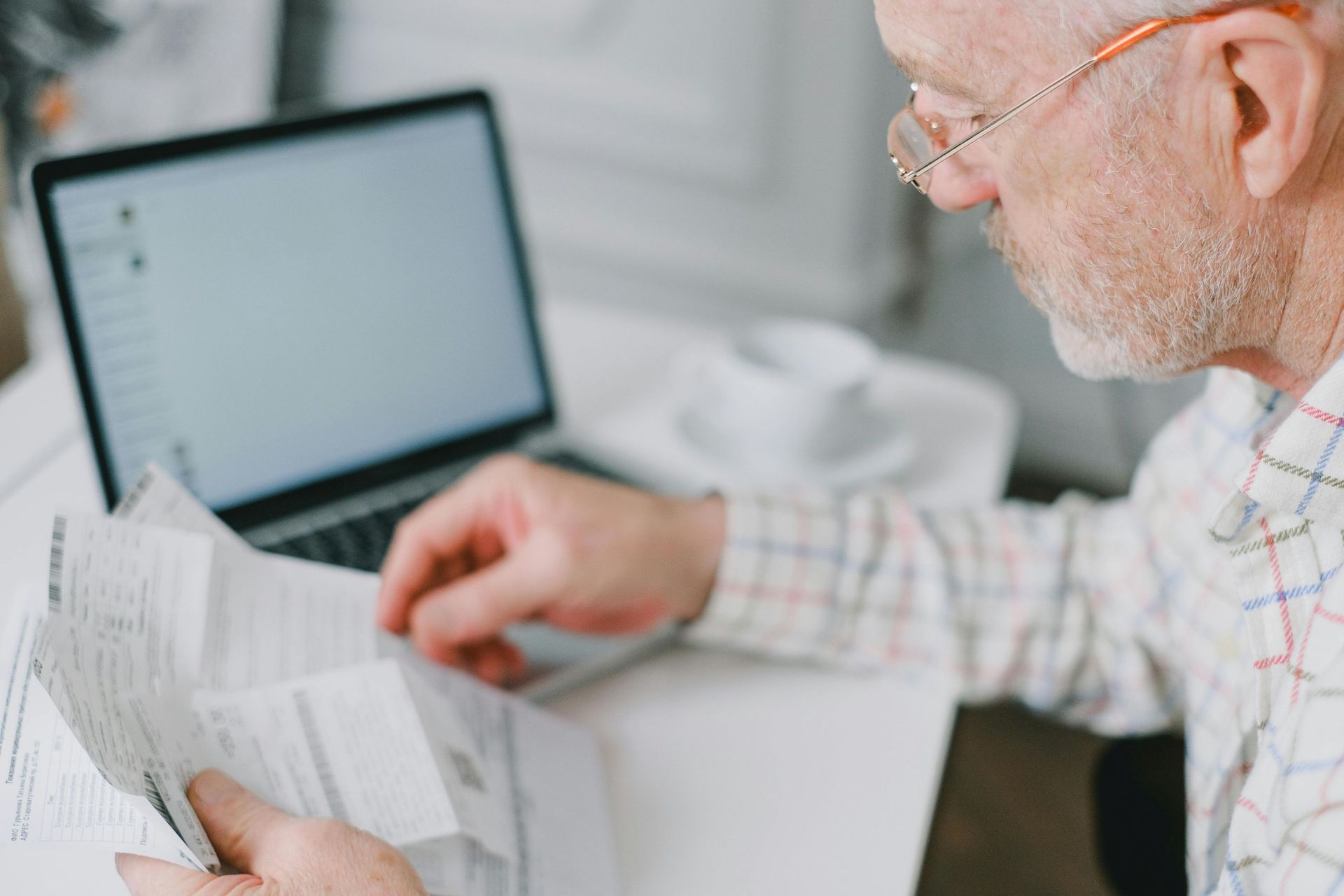A male retiree looking at financial documents.