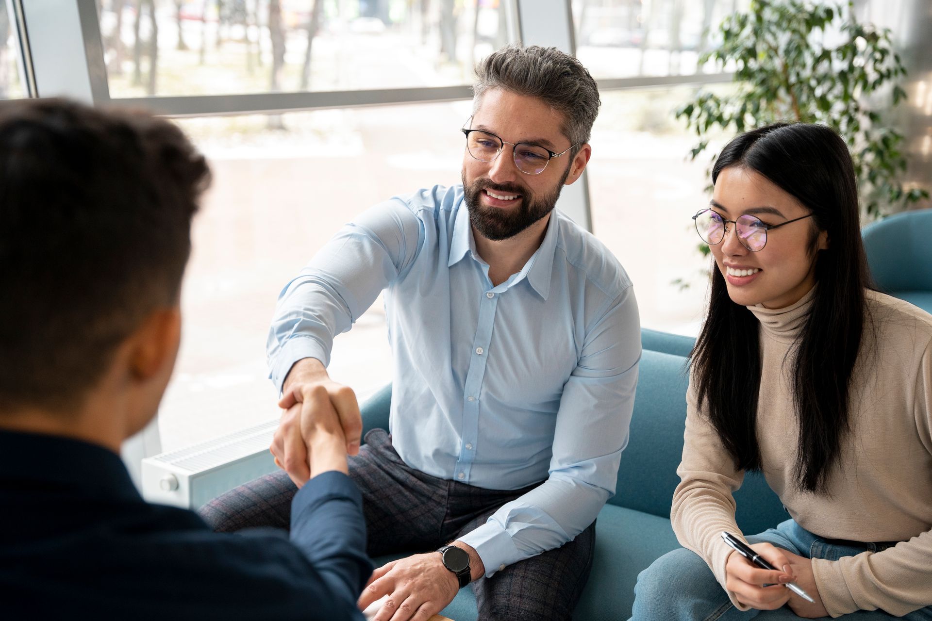 A professional mortgage broker meeting with clients.
