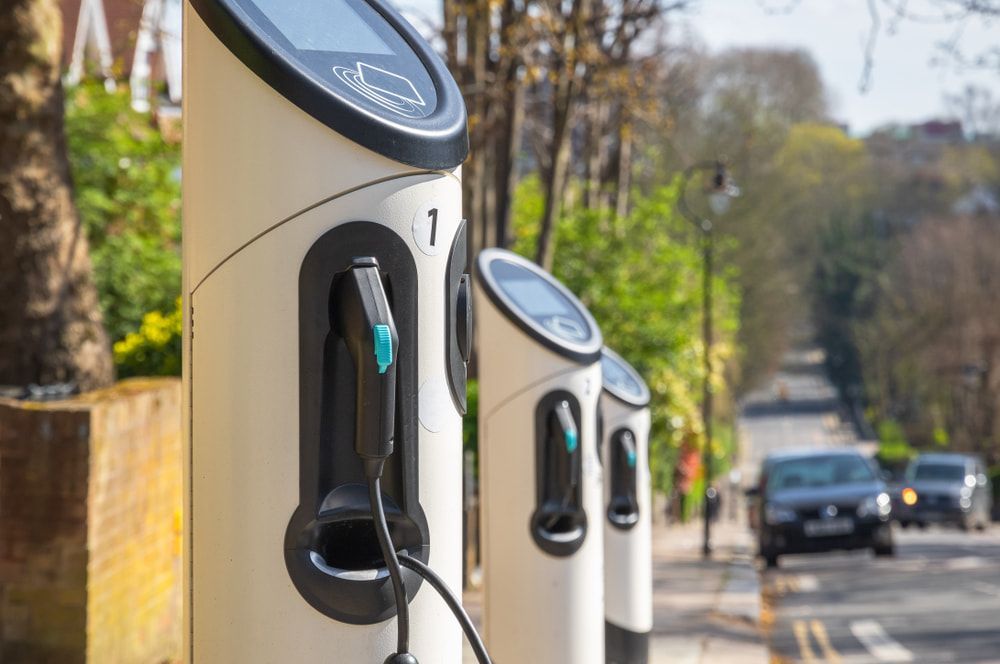 A Row of Electric Car Charging Stations on the Side of a Road — Ray Smith Electrical in Korora, NSW