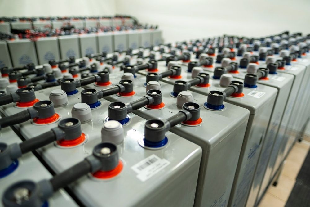 A Row of Batteries Are Lined Up in a Room — Ray Smith Electrical in Korora, NSW