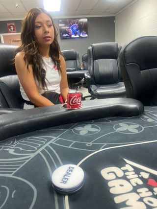 A man and a woman are playing poker in a casino.