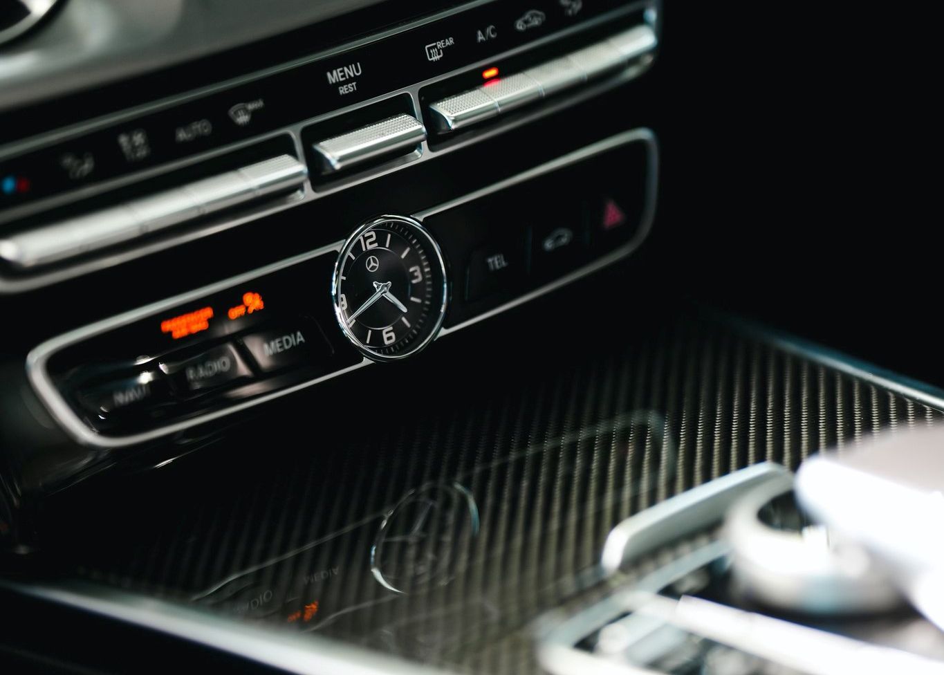 A close up of a car dashboard with a clock on it.