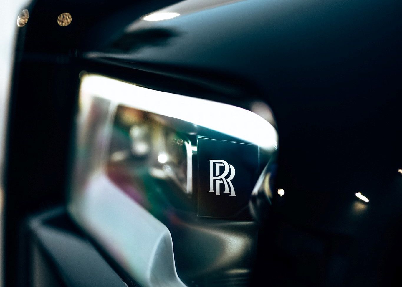A close up of a Rolls Royce car headlight.