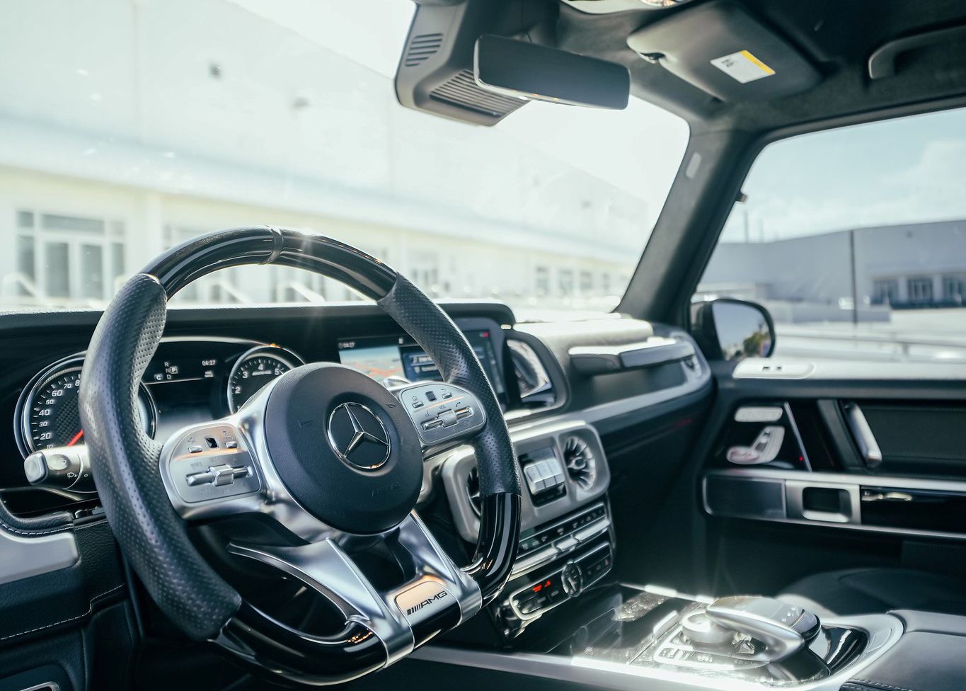 A close up of the steering wheel and dashboard of a Mercedes Benz G550.