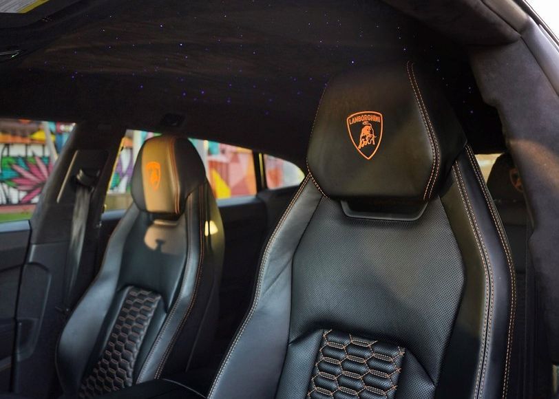 A close up of the seats in a Lamborghini car.