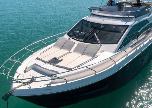 A large white yacht is floating on top of a body of water.