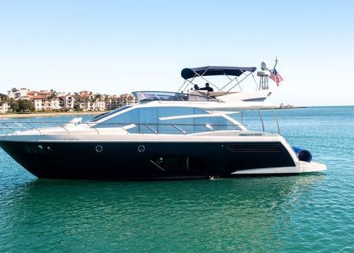 A large yacht is floating on top of a body of water.