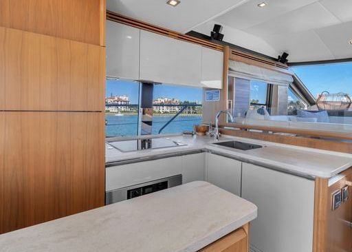 A kitchen on a boat with a view of the water.