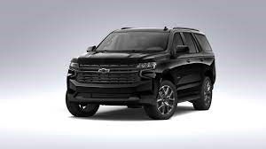 A black SUV is parked on a white surface.