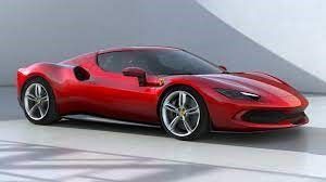 A red Ferrari sports car is parked in a garage.