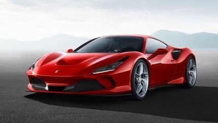 A red sports car is parked on the side of the road.