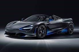 A black and blue sports car is parked on a gray surface.