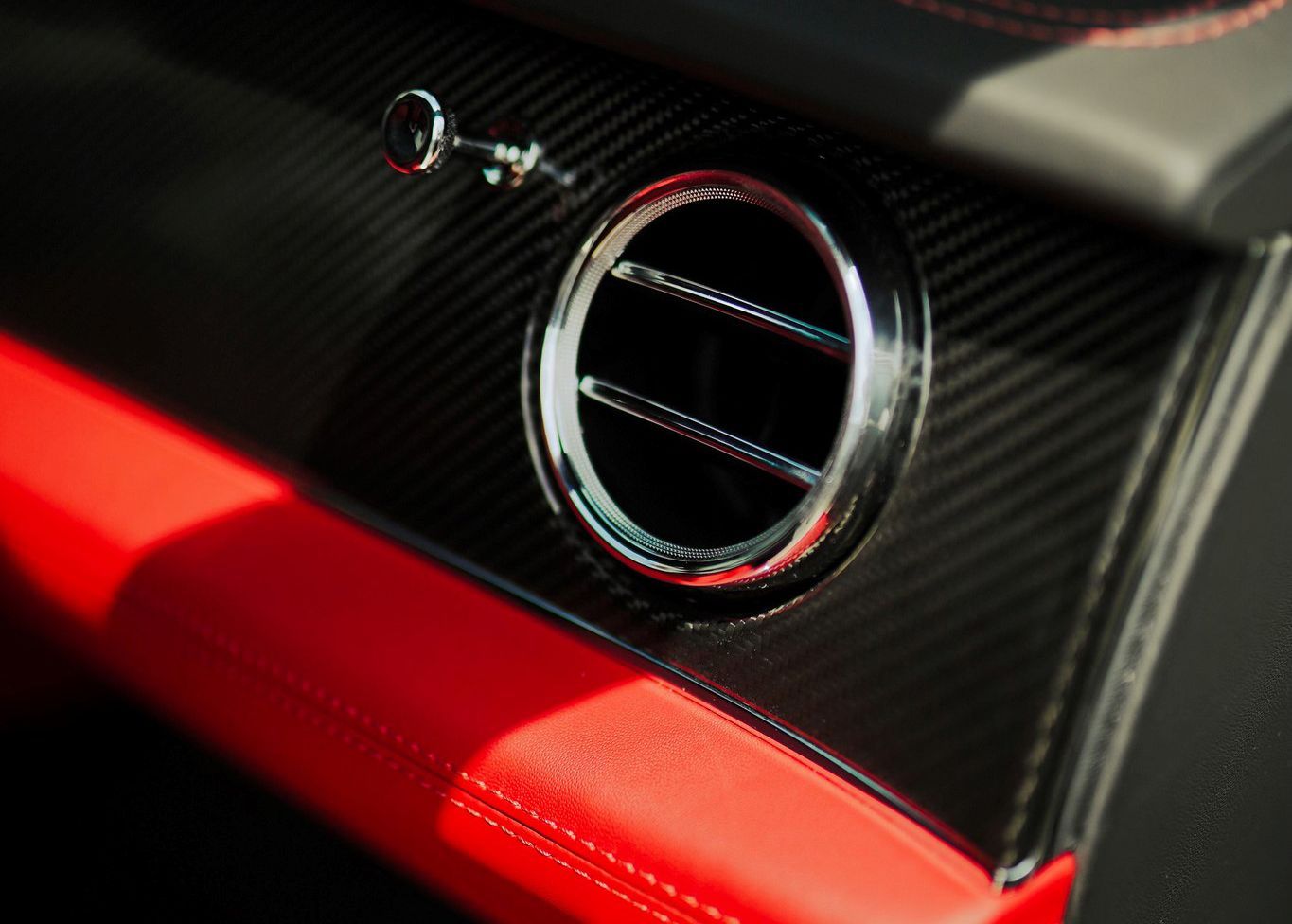 A close up of the air vent on the side of a car.