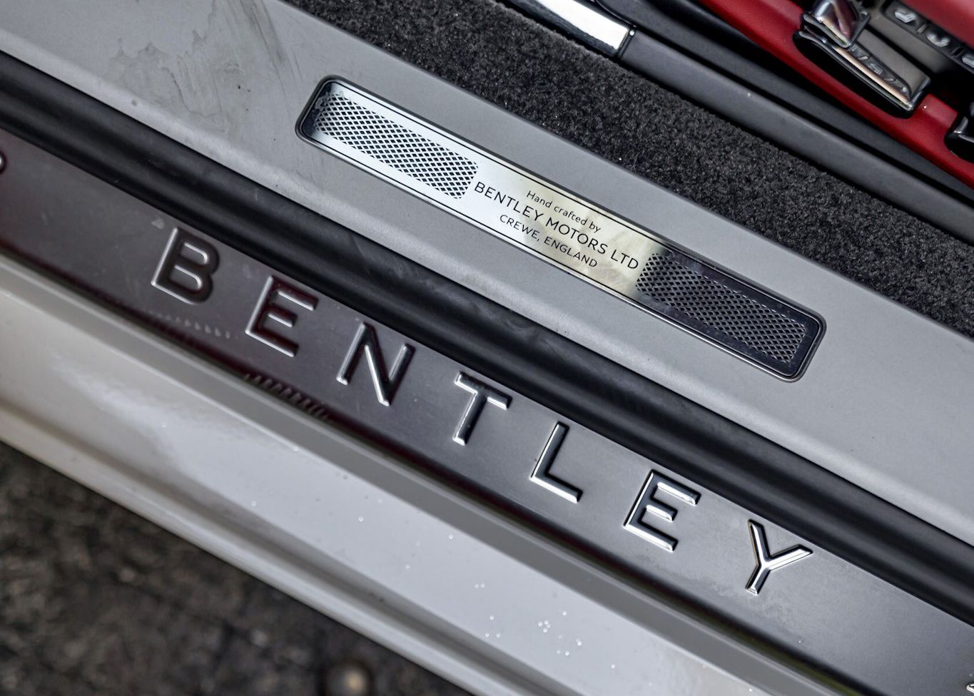 The word Bentley is on the side of a car.
