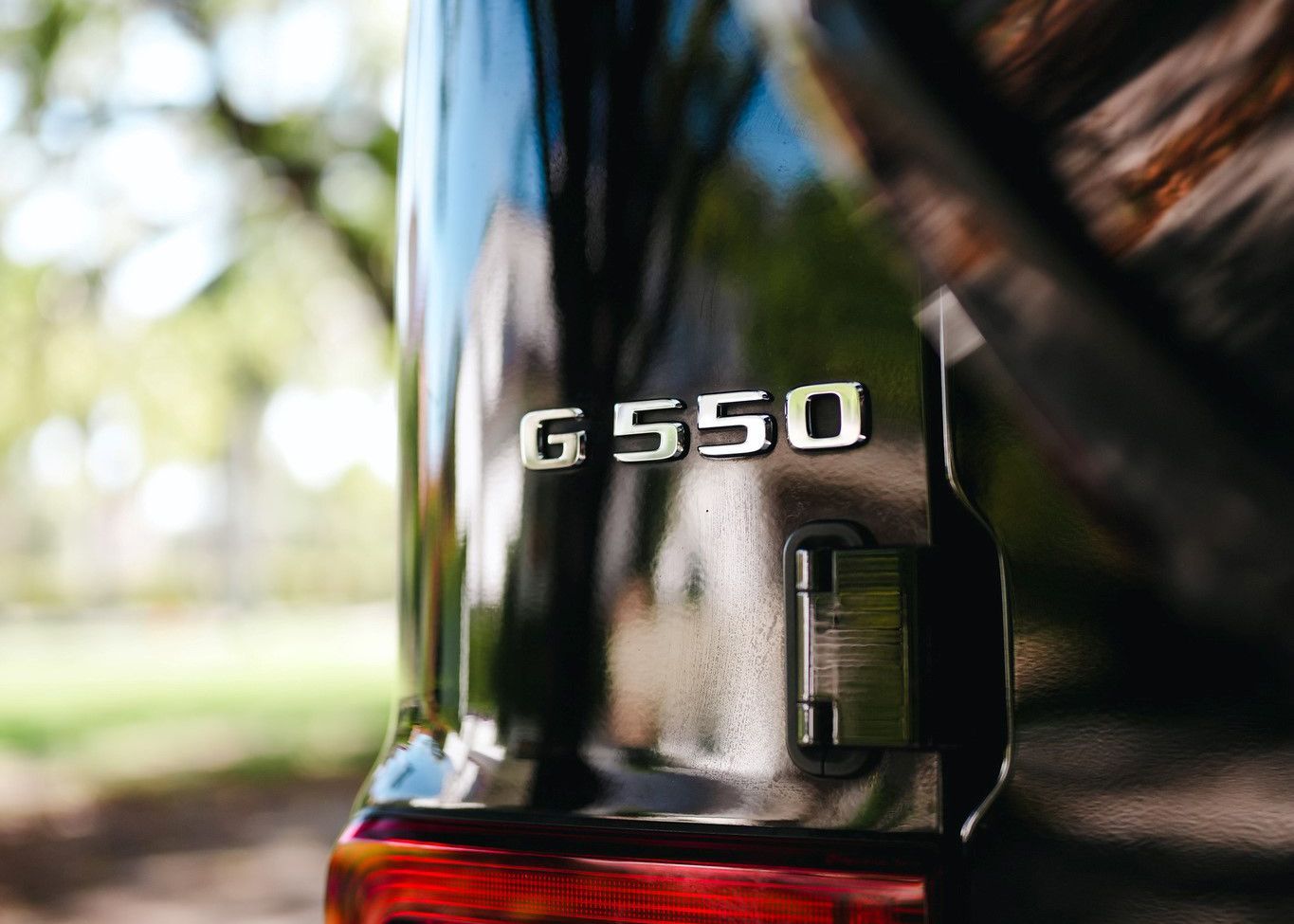 A close up of the back of a black Mercedes Benz G550.
