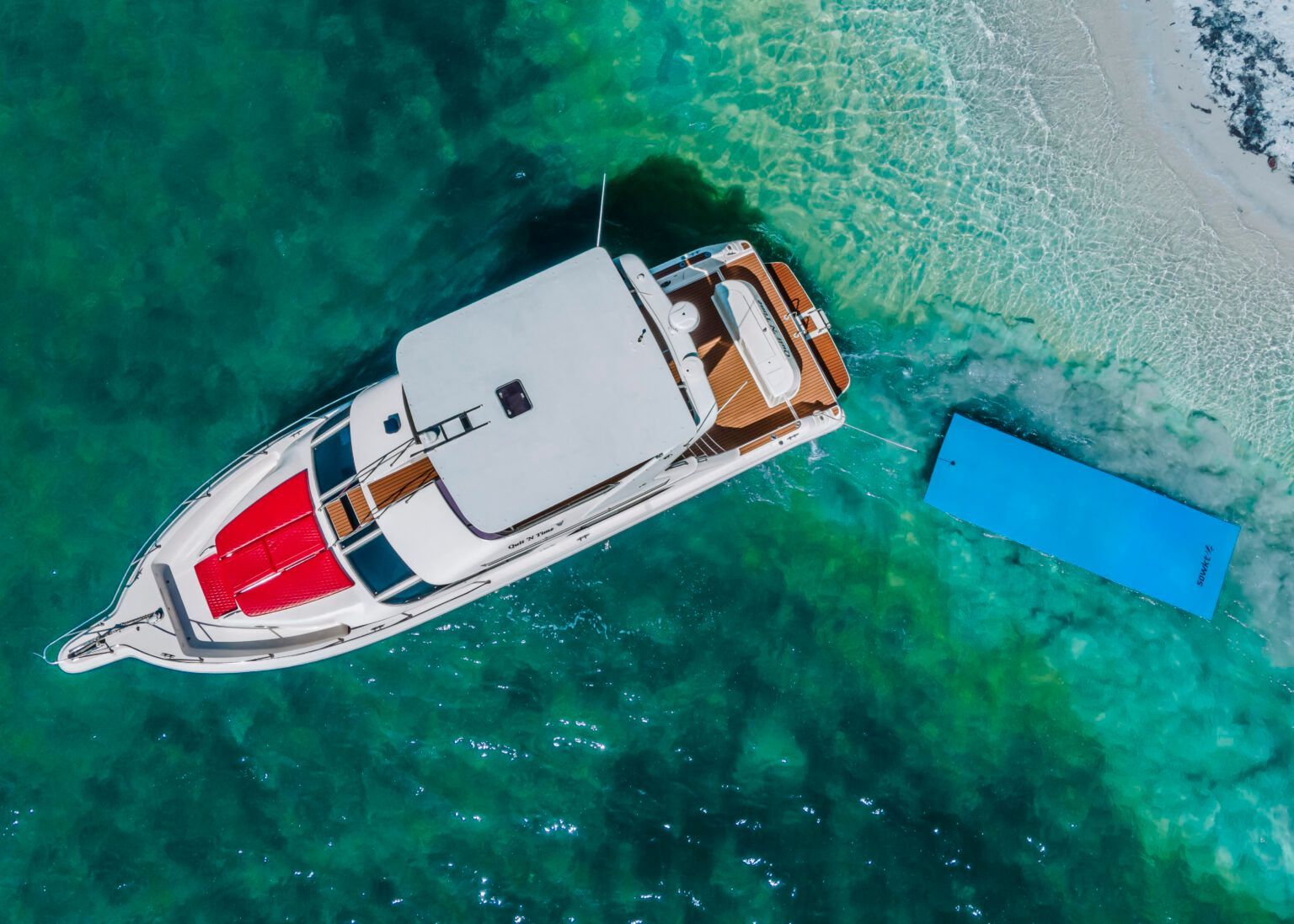 An aerial view of a boat floating on top of a body of water.