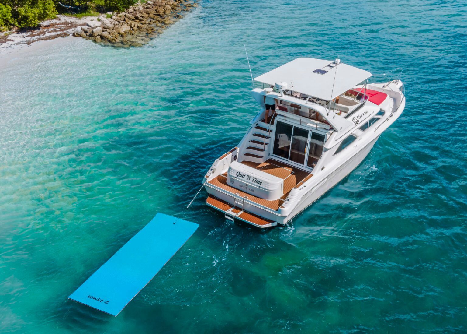 An aerial view of a boat floating on top of a body of water.