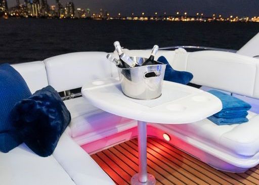 A boat has a table with a bucket of wine on it.