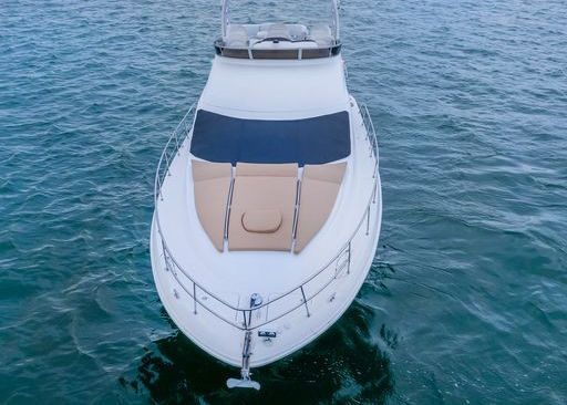 A white yacht is floating on top of a body of water.