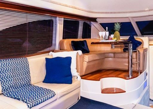 A living room on a boat with a couch and a table.