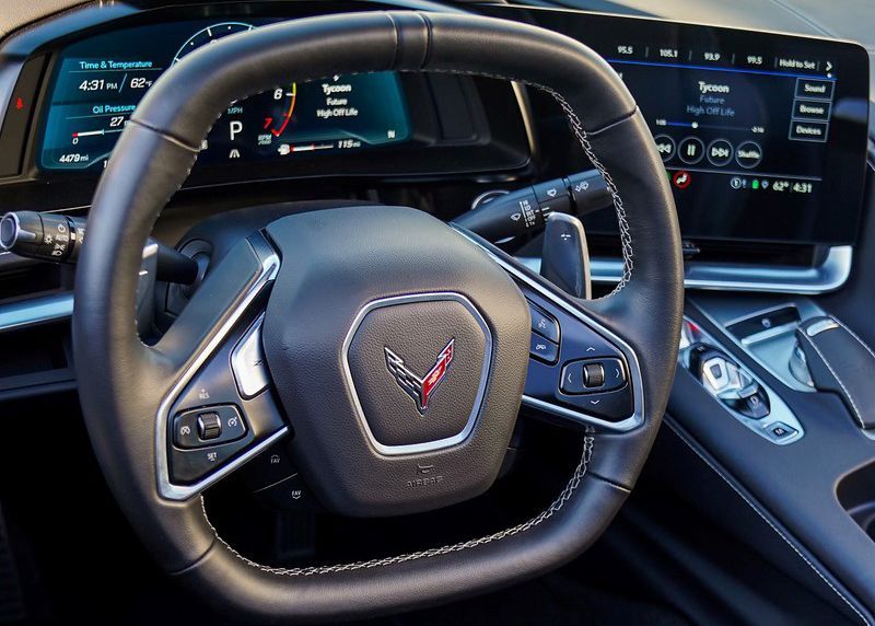 A close up of a Corvette steering wheel and dashboard.