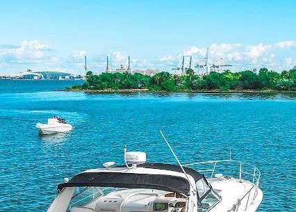 A white boat is docked in the middle of a large body of water.