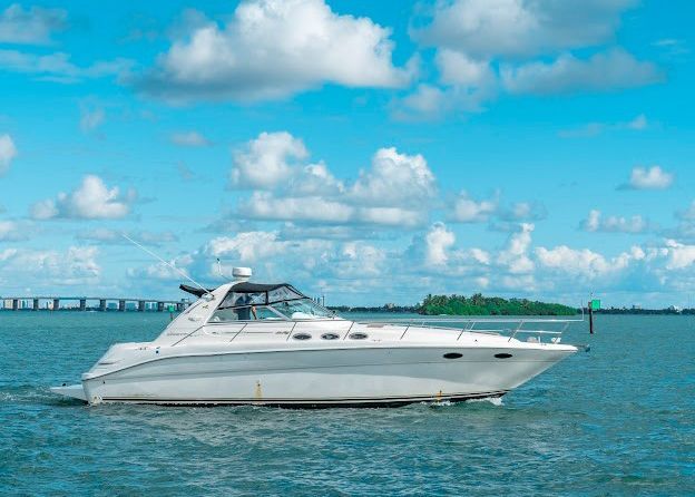 A white yacht is floating on top of a body of water.