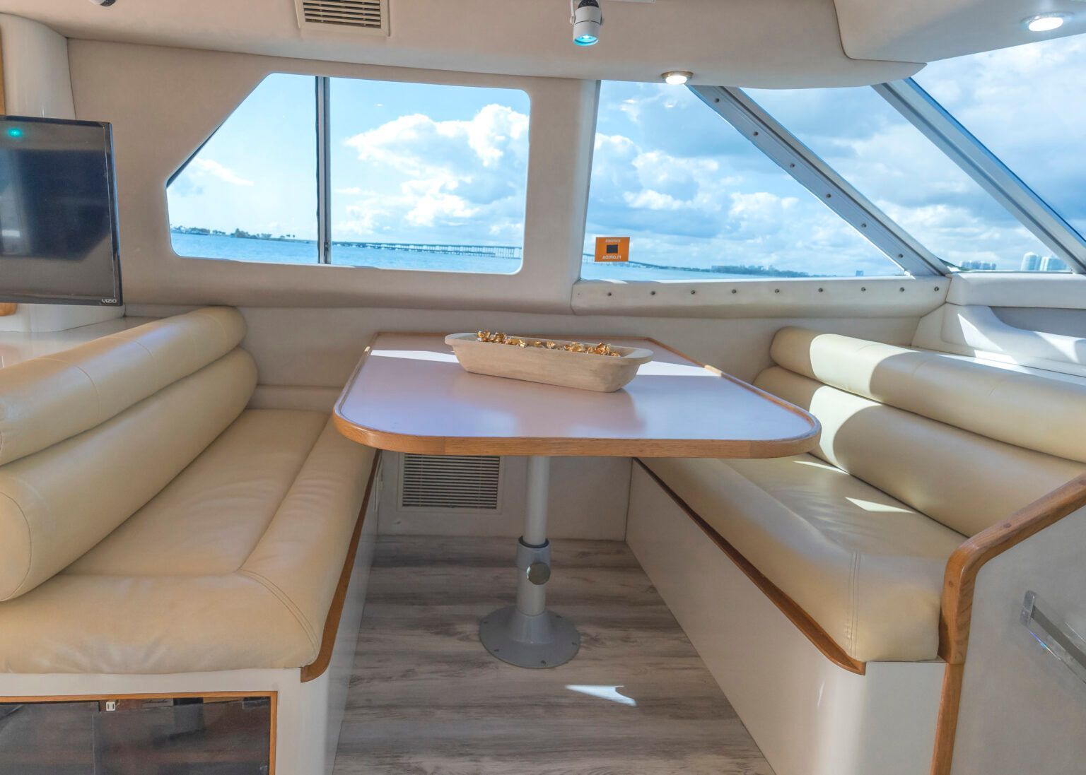 The inside of a boat with a table and couch.