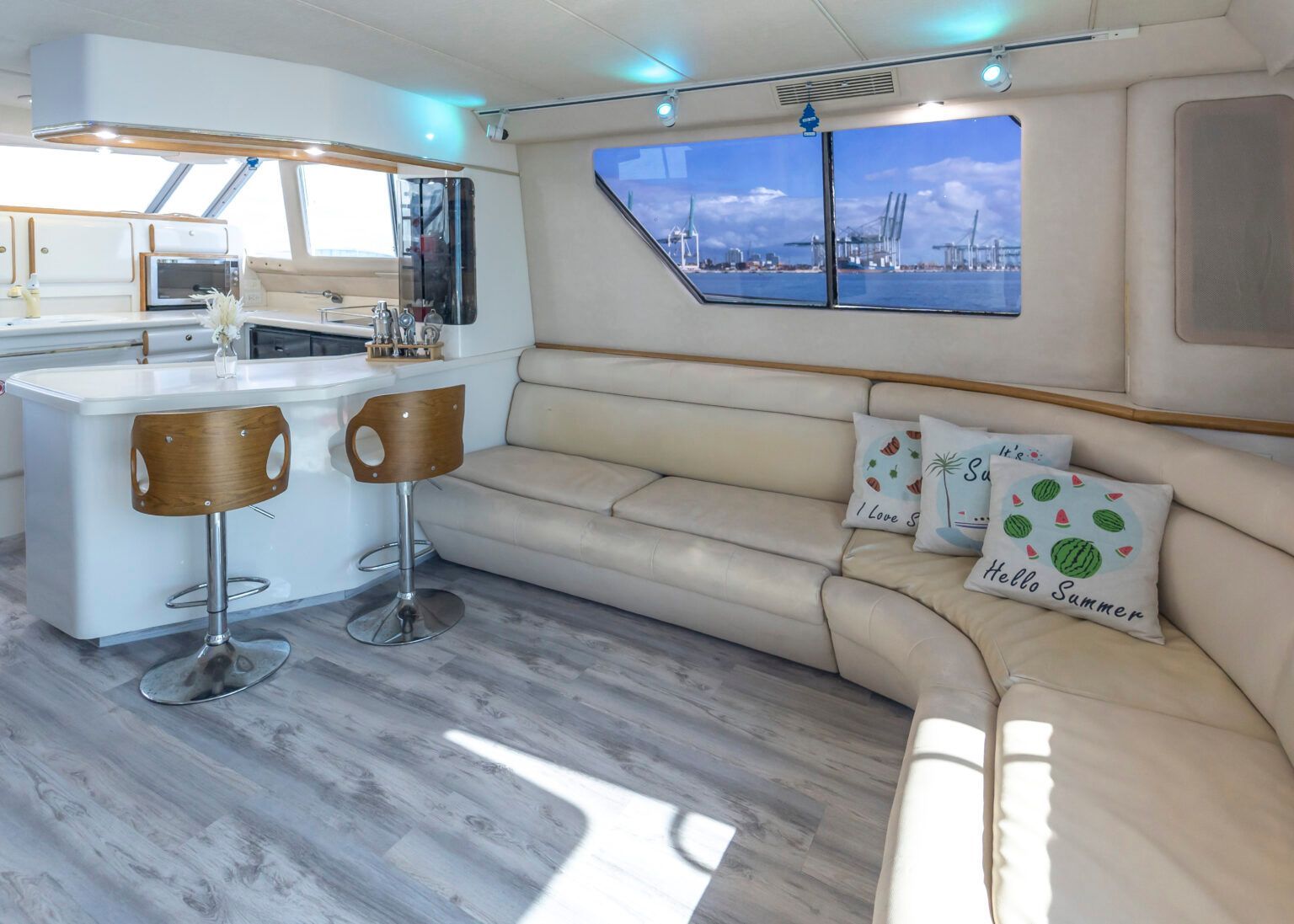 A living room on a boat with a couch and a bar.