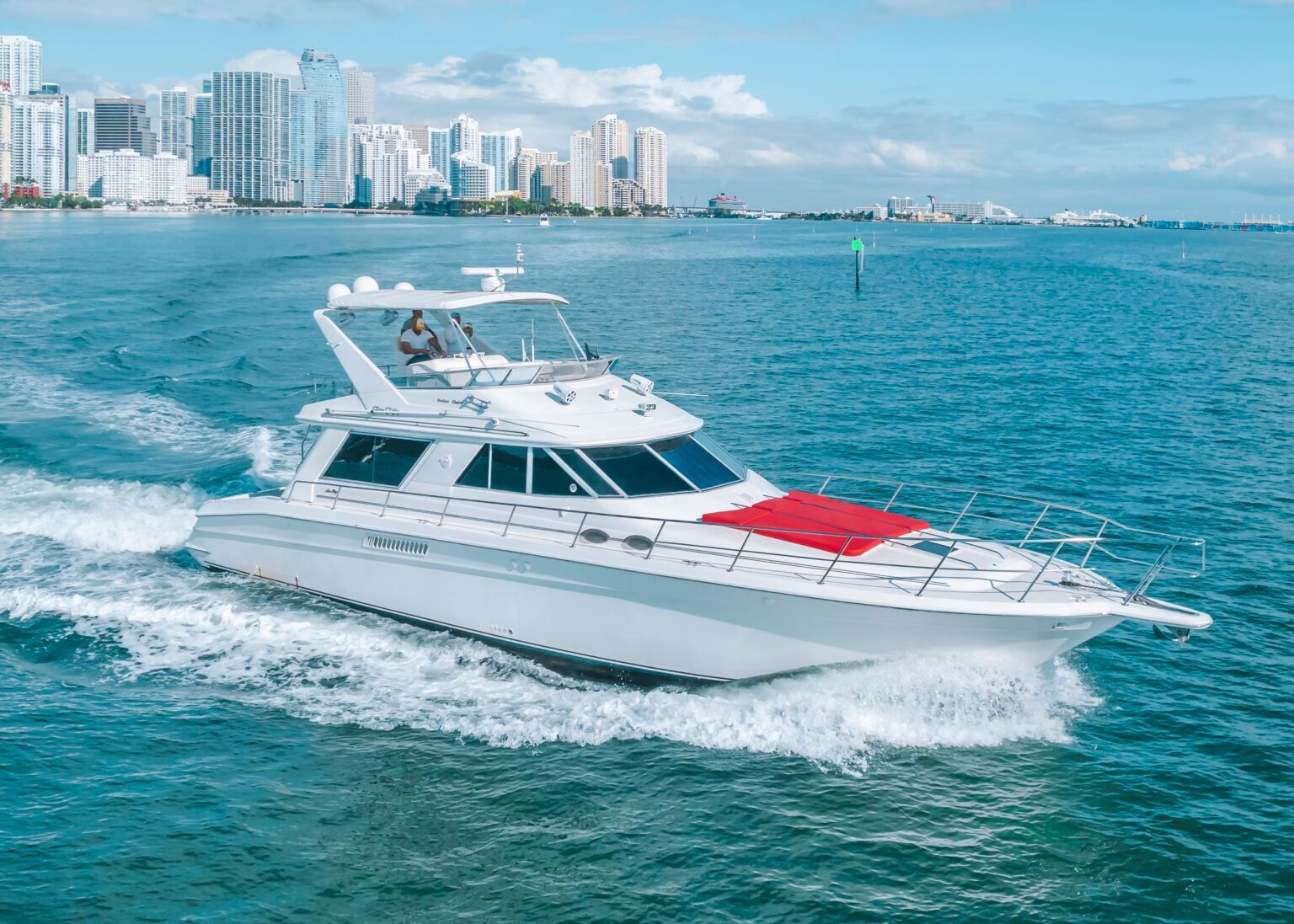 A white yacht is floating on top of a body of water.