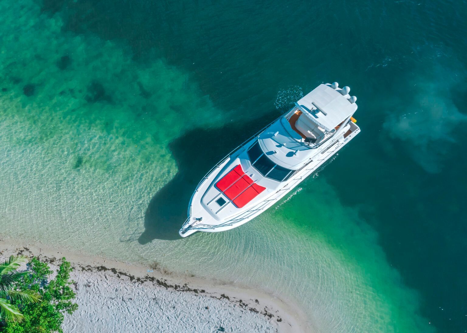 An aerial view of a yacht floating on top of a body of water.