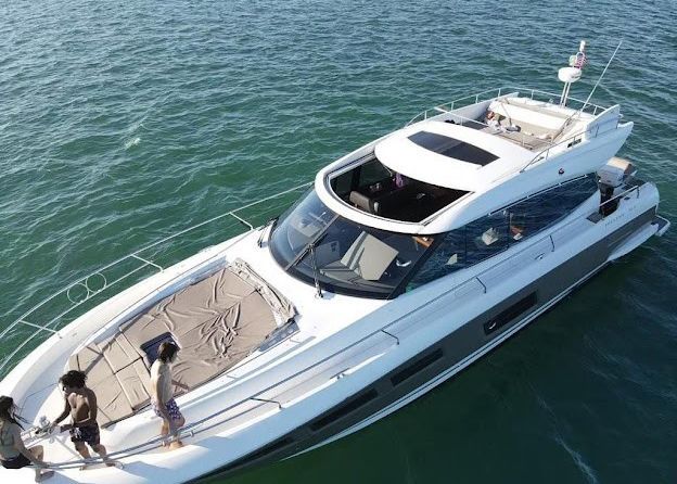 A large white yacht is floating on top of a body of water.