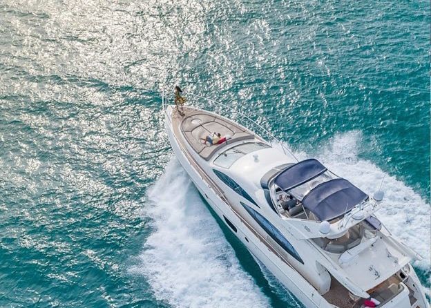 An aerial view of a yacht floating on top of a body of water.